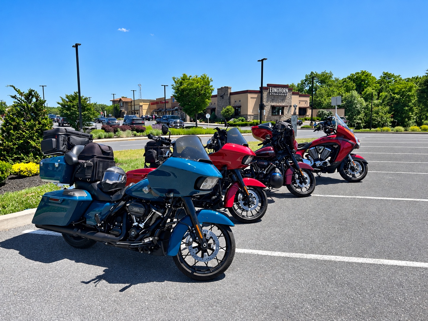 Touring motorcycles parked together at a road-trip stop