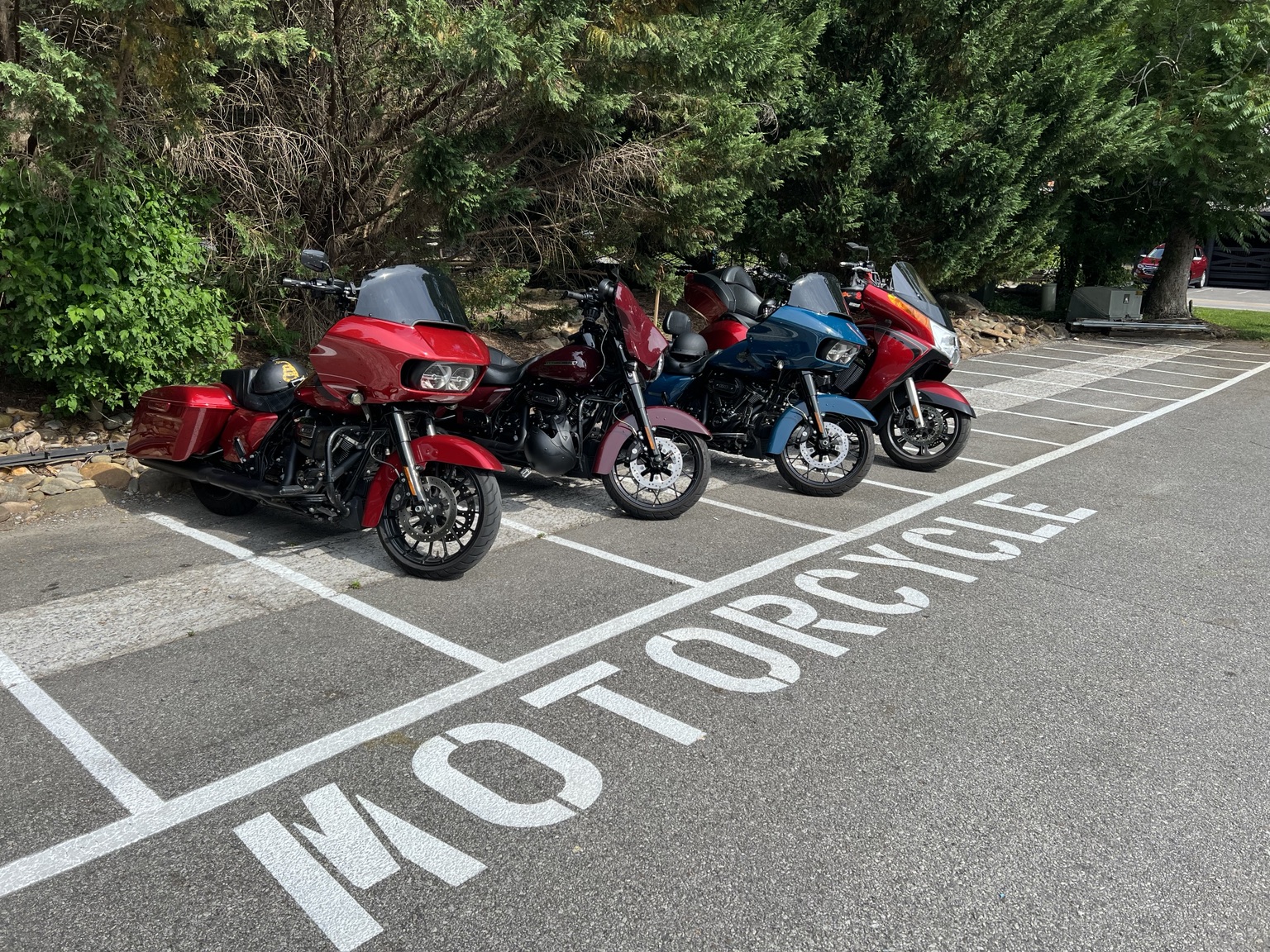 Group of touring motorcycles parked together at a ride stop